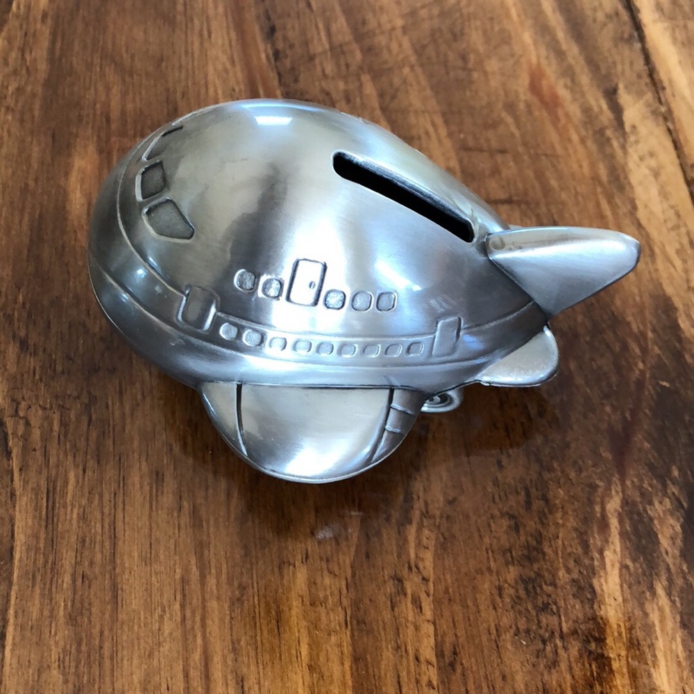 Adorable metal piggy bank.